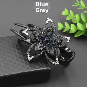 Detail of blue grey crystal flower hairpin on a premium leather texture display box