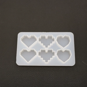 Macro shot of 6-cavity heart silicone mold for resin art with pixel and geometric styles