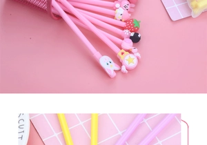 Detailed macro view of cute cartoon gel pens featuring silicone animal toppers on desk
