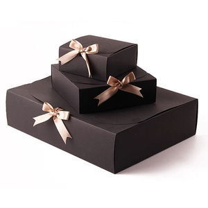 Three-piece black nested gift boxes with elegant rose gold ribbon bows on white background
