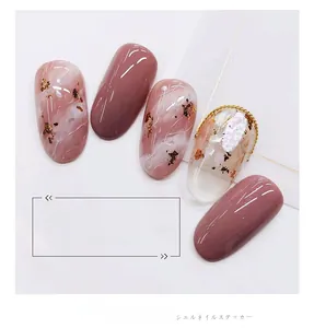 Detail of 3D shell texture and gold foil accents on mauve marble nail art stickers