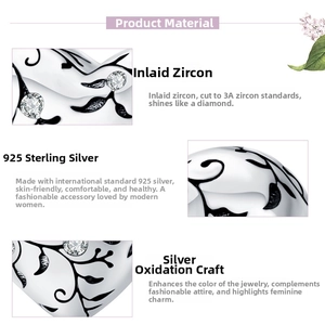 Macro detail of 925 sterling silver heart charm with oxidized patterns and 3A cubic zirconia