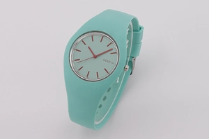 Detail view of mint green silicone strap and Geneva watch face with red hands