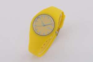 Detail of a vibrant yellow Geneva quartz watch with a silicone strap and sky blue indices