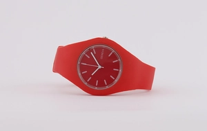 Close-up detail of a minimalist red silicone quartz watch with integrated band design
