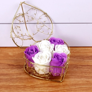 Close-up of heart-shaped gold wire basket with elegant white and purple soap roses