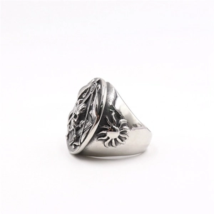 Macro view of vintage stainless steel skull ring with detailed engravings and sun motifs