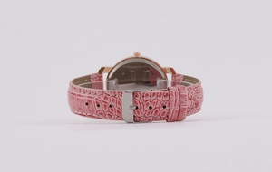 Detail view of pink crocodile leather strap and rose gold case on women quartz watch