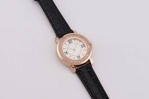 Detail view of rose gold watch with sparkling rhinestones and black faux crocodile strap