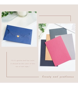 Close-up of pearlized envelope set with gold heart seal and premium matte paper texture