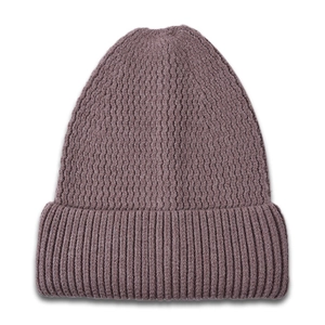 Detail of ribbed knit texture and wave pattern on a warm mauve winter beanie hat