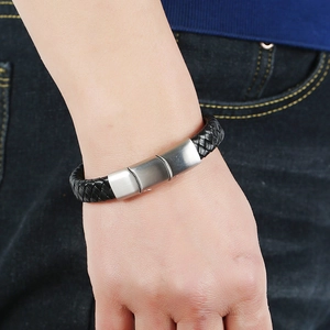 Men's black braided leather bracelet with silver magnetic stainless steel clasp on wrist