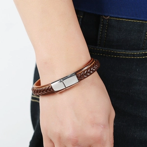Brown braided leather bracelet with silver magnetic buckle on male wrist