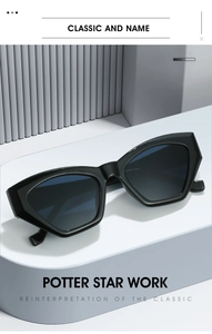 Detail of chunky black cat eye sunglasses with thick frames and dark grey lenses