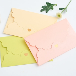 Pastel wavy edge envelopes with heart-shaped closure for weddings and invitations