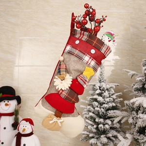 Detail of Christmas stocking with 3D Santa Claus figure and festive red berry accents