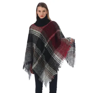 Women's plaid poncho sweater with turtleneck and fringe hem in classic red and black