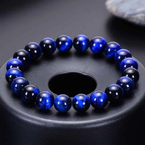 Natural blue tiger eye stone bracelet with eagle eye beads on black display base