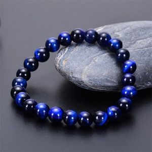 Macro detail of blue tiger eye stone beads showing natural chatoyant silk luster