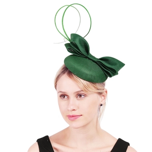 Detail of green woven fascinator hat with elegant bow and decorative wire loops