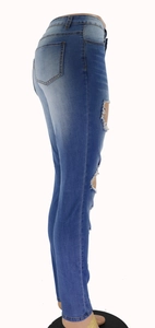 Detailed close-up showing distressed ripped denim and blue wash texture on high waist jeans