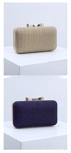 Detail of evening clutch featuring pleated shimmer fabric and a gold bow-shaped clasp