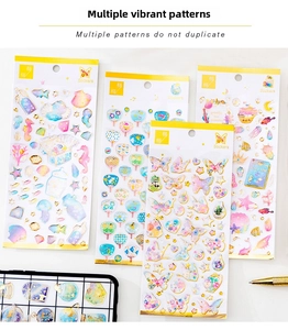 Detail of 4-pack gold-stamped crystal stickers featuring butterfly and ocean themes