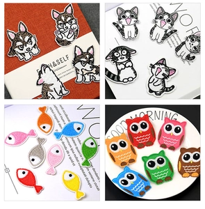 Detail showing various colorful cartoon animal embroidered patches on a white background