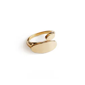 Macro shot of 18K gold plated oval bean open ring with mirror polished geometric finish