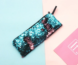 Close-up of reversible turquoise and purple sequins on a rectangular zipper pencil case