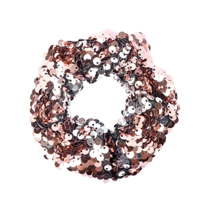 Detailed view of two-tone rose gold and black reversible sequin hair tie for girls
