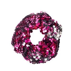 Detailed view of two-tone sequin hair scrunchie in shimmering rose red and silver colors