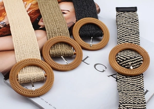 Detail of woven straw belts with large round buckles in four bohemian colors and patterns