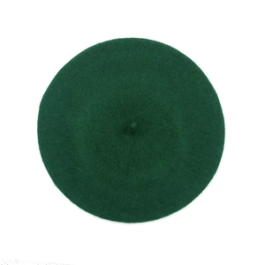 Classic dark green wool beret hat for women with a vintage winter style on white background
