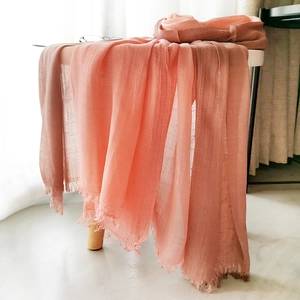 Detailed macro of pink gradient cotton linen scarf with elegant fringe edge finish
