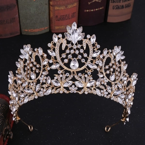 Detailed macro of a golden Baroque bridal crown with crystals on vintage books