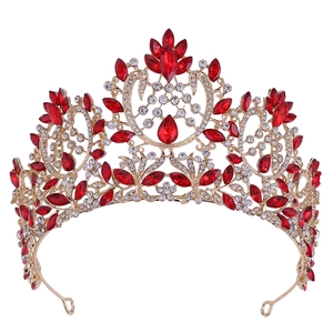 Detailed view of Baroque bridal crown with red rhinestones on a gold metal base