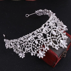 Close-up of luxury Baroque bridal crown with silver crystals on a vintage wooden box