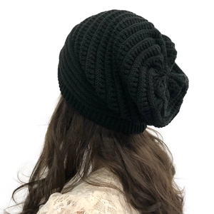 Detail of black chunky knit beanie for women showing thick texture and slouchy back design