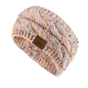 Close-up of confetti knit headband featuring chunky cable stitch and brown leather logo tag