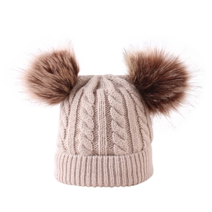 Beige cable knit baby beanie with double brown faux fur pom poms for winter warmth