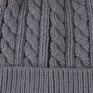 Close-up of gray cable-knit texture and ribbed elastic cuff on infant winter hat