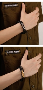Close-up of double-layer woven leather bracelets with silver and gold metal U-shaped buckles