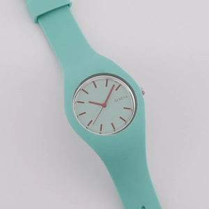 Mint green silicone strap watch with red markers and round Geneva dial on white background