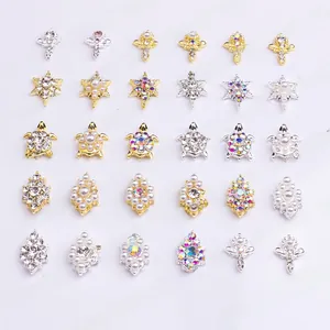 Macro view of gold and silver alloy nail art charms featuring sun flowers and turtle designs