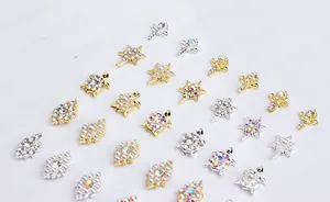 Detailed close-up of alloy nail charms with turtle shapes and white pearls in gold and silver