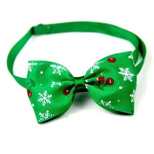 Green Christmas pet bowtie with snowflake and cherry patterns on white background