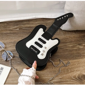 Detail of creative electric guitar shoulder bag featuring black white contrast and star studs