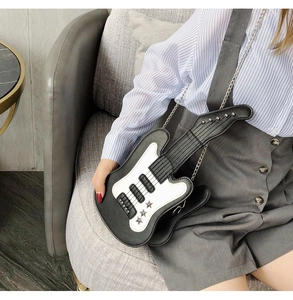 Detailed shot of guitar-shaped crossbody bag with silver star rivets and metal chain strap