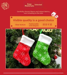 Detail of red and green Christmas stockings with snowflake patterns hanging on a tree
